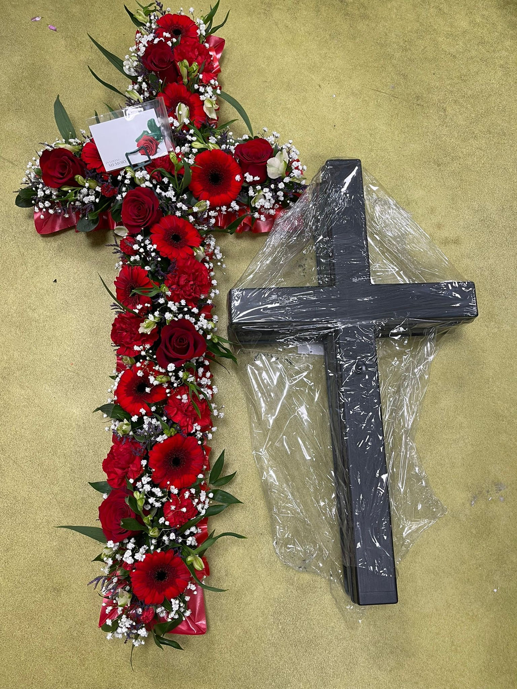 Cross shaped funeral wreath of fresh flowers