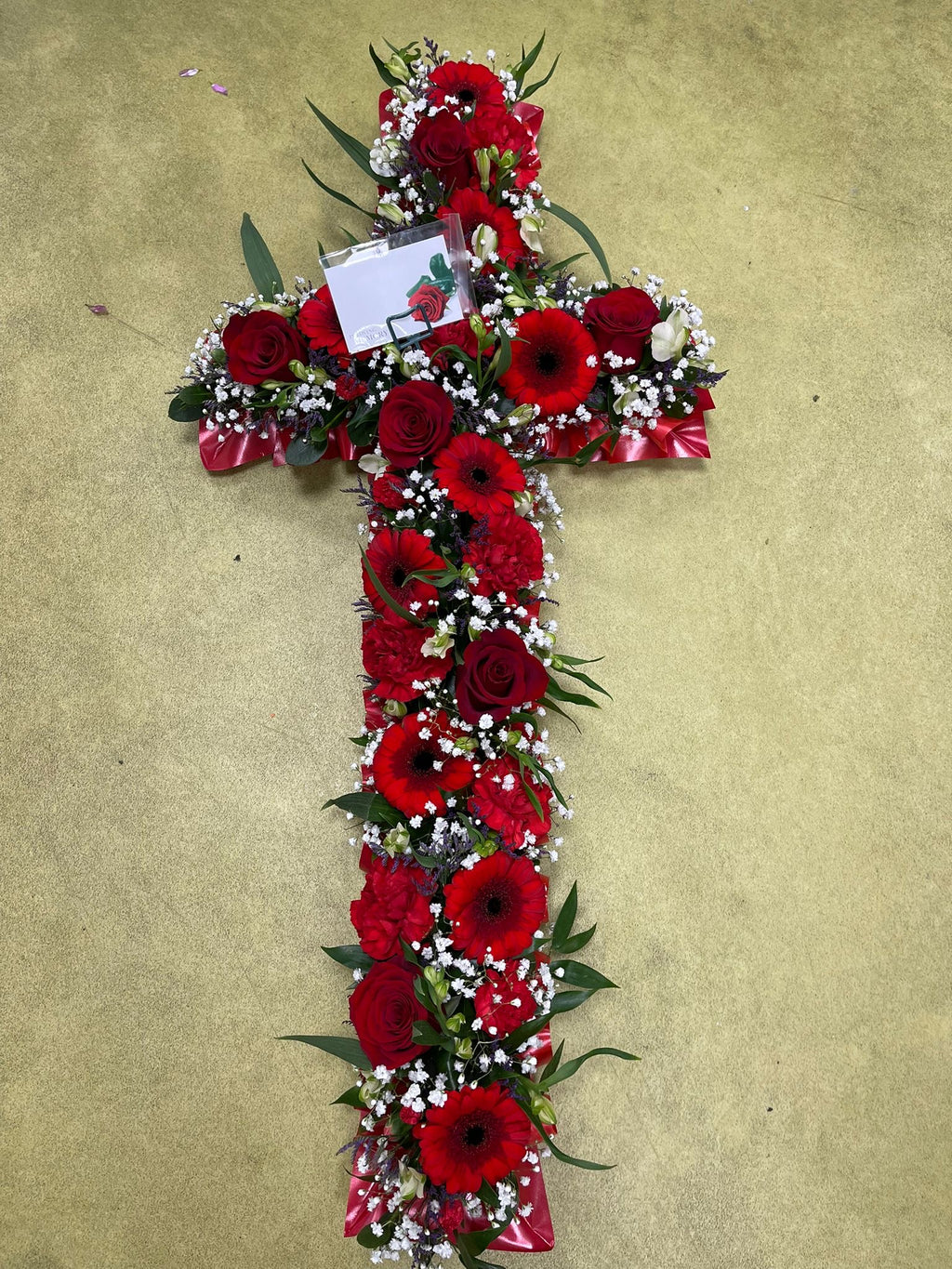 Cross shaped funeral wreath of fresh flowers